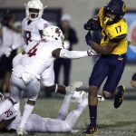 California's Makai Polk, right, evades the tackle of Washington State's Marcus Strong (4) on his touchdown run in the second half of an NCAA college football game Saturday, Nov. 9, 2019, in Berkeley, Calif. (AP Photo/Ben Margot)