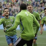 Seattle Sounders' Victor Rodriguez, left, celebrates with teammates after scoring against the Toronto FC, Sunday, Nov. 10, 2019, during the second half of the MLS Cup championship soccer match in Seattle. (AP Photo/Ted S. Warren)