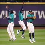 SEATTLE, WASHINGTON - JULY 31: (L-R) Dylan Moore #25, Kyle Lewis #1 and Dee Gordon #9 of the Seattle Mariners celebrate their Opening Day 5-3 win against the Oakland Athletics at T-Mobile Park on July 31, 2020 in Seattle, Washington. (Photo by Abbie Parr/Getty Images)