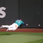 SEATTLE, WASHINGTON - JULY 31: Dylan Moore #25 of the Seattle Mariners dives for a double by Marcus Semien #10 of the Oakland Athletics in the eighth inning during their Opening Day game at T-Mobile Park on July 31, 2020 in Seattle, Washington. (Photo by Abbie Parr/Getty Images)