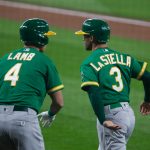 SEATTLE, WA - SEPTEMBER 14:  Tommy La Stella #3 of the Oakland Athletics is greeted by Jake Lamb #4 after scoring on a single by Mark Canha #20 during the first inning against the Seattle Mariners in the second game of a doubleheader at T-Mobile Park on September 14, 2020 in Seattle, Washington. (Photo by Lindsey Wasson/Getty Images)