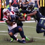 SEATTLE, WASHINGTON - SEPTEMBER 20: N'Keal Harry #15 of the New England Patriots is tackled by Shaquill Griffin #26 and Quandre Diggs #37 of the Seattle Seahawks during the first half at CenturyLink Field on September 20, 2020 in Seattle, Washington. (Photo by Abbie Parr/Getty Images)