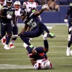 SEATTLE, WASHINGTON - SEPTEMBER 20: Shaquill Griffin #26 of the Seattle Seahawks jumps over N'Keal Harry #15 of the New England Patriots during the second half at CenturyLink Field on September 20, 2020 in Seattle, Washington. (Photo by Abbie Parr/Getty Images)
