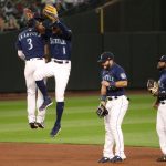 SEATTLE, WASHINGTON - SEPTEMBER 21: J.P. Crawford #3 and Kyle Lewis #1 of the Seattle Mariners celebrate their 6-1 win against the Houston Astros at T-Mobile Park on September 21, 2020 in Seattle, Washington. (Photo by Abbie Parr/Getty Images)