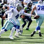 SEATTLE, WASHINGTON - SEPTEMBER 27: Dak Prescott #4 of the Dallas Cowboys fakes a handoff against the Seattle Seahawks during the first quarter in the game at CenturyLink Field on September 27, 2020 in Seattle, Washington. (Photo by Abbie Parr/Getty Images)