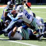 SEATTLE, WASHINGTON - SEPTEMBER 27: Ezekiel Elliott #21 of the Dallas Cowboys dives for the end zone to score a touchdown against the Seattle Seahawks during the first quarter in the game at CenturyLink Field on September 27, 2020 in Seattle, Washington. (Photo by Abbie Parr/Getty Images)