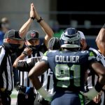 SEATTLE, WASHINGTON - SEPTEMBER 27: The referee signals for a safety after Ezekiel Elliott #21 of the Dallas Cowboys got tackled in the end zone against the Seattle Seahawks during the first quarter in the game at CenturyLink Field on September 27, 2020 in Seattle, Washington. (Photo by Abbie Parr/Getty Images)