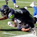 SEATTLE, WASHINGTON - SEPTEMBER 27: Chris Carson #32 of the Seattle Seahawks dives out of bounds just short of the end zone against the Dallas Cowboys during the second quarter in the game at CenturyLink Field on September 27, 2020 in Seattle, Washington. (Photo by Abbie Parr/Getty Images)