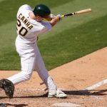 OAKLAND, CALIFORNIA - SEPTEMBER 27: Mark Canha #20 of the Oakland Athletics hits a bases loaded two-run RBI double against the Seattle Mariners in the bottom of the seventh inning at RingCentral Coliseum on September 27, 2020 in Oakland, California. (Photo by Thearon W. Henderson/Getty Images)