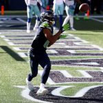 SEATTLE, WASHINGTON - SEPTEMBER 27: Tyler Lockett #16 of the Seattle Seahawks catches a one yard touchdown pass against the Dallas Cowboys during the second quarter in the game at CenturyLink Field on September 27, 2020 in Seattle, Washington. (Photo by Abbie Parr/Getty Images)