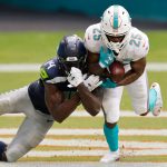 MIAMI GARDENS, FLORIDA - OCTOBER 04: Xavien Howard #25 of the Miami Dolphins intercepts a pass intended for DK Metcalf #14 of the Seattle Seahawks during the third quarter at Hard Rock Stadium on October 04, 2020 in Miami Gardens, Florida. (Photo by Michael Reaves/Getty Images)