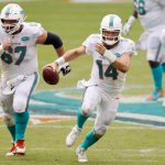 MIAMI GARDENS, FLORIDA - OCTOBER 04: Ryan Fitzpatrick #14 of the Miami Dolphins runs with the ball against the Seattle Seahawks during the second half at Hard Rock Stadium on October 04, 2020 in Miami Gardens, Florida. (Photo by Michael Reaves/Getty Images)