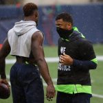 SEATTLE, WASHINGTON - OCTOBER 11: DK Metcalf #14 and Russell Wilson #3 of the Seattle Seahawks warm up against the Minnesota Vikings at CenturyLink Field on October 11, 2020 in Seattle, Washington. (Photo by Abbie Parr/Getty Images)