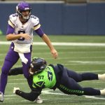 SEATTLE, WASHINGTON - OCTOBER 11: Kirk Cousins #8 of the Minnesota Vikings is pressured by Poona Ford #97 of the Seattle Seahawks during the first quarter at CenturyLink Field on October 11, 2020 in Seattle, Washington. (Photo by Abbie Parr/Getty Images)