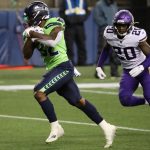 SEATTLE, WASHINGTON - OCTOBER 11: Chris Carson #32 of the Seattle Seahawks scores a touchdown against Jeff Gladney #20 of the Minnesota Vikings during the third quarter at CenturyLink Field on October 11, 2020 in Seattle, Washington. (Photo by Abbie Parr/Getty Images)