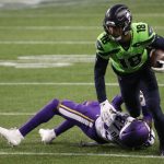 SEATTLE, WASHINGTON - OCTOBER 11: Freddie Swain #18 of the Seattle Seahawks is tackled by Cameron Dantzler #27 of the Minnesota Vikings during the third quarter at CenturyLink Field on October 11, 2020 in Seattle, Washington. (Photo by Abbie Parr/Getty Images)