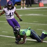 SEATTLE, WASHINGTON - OCTOBER 11: DK Metcalf #14 of the Seattle Seahawks scores a touchdown against Anthony Harris #41 of the Minnesota Vikings during the third quarter at CenturyLink Field on October 11, 2020 in Seattle, Washington. (Photo by Abbie Parr/Getty Images)