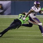 SEATTLE, WASHINGTON - OCTOBER 11: Mike Boone #23 of the Minnesota Vikings is tackled by Ryan Neal #35 of the Seattle Seahawks during the fourth quarter at CenturyLink Field on October 11, 2020 in Seattle, Washington. (Photo by Abbie Parr/Getty Images)