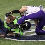 SEATTLE, WASHINGTON - OCTOBER 11: DK Metcalf #14 of the Seattle Seahawks catches the game winning touchdown pass against Harrison Smith #22 of the Minnesota Vikings during the fourth quarter at CenturyLink Field on October 11, 2020 in Seattle, Washington. (Photo by Abbie Parr/Getty Images)