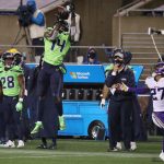 SEATTLE, WASHINGTON - OCTOBER 11: DK Metcalf #14 of the Seattle Seahawks catches a pass on fourth down during the fourth quarter against Cameron Dantzler #27 of the Minnesota Vikings at CenturyLink Field on October 11, 2020 in Seattle, Washington. (Photo by Abbie Parr/Getty Images)