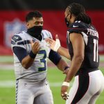 GLENDALE, ARIZONA - OCTOBER 25: Quarterback Russell Wilson #3 of the Seattle Seahawks and wide receiver Larry Fitzgerald #11 of the Arizona Cardinals shake hands at the coin toss prior to the game at State Farm Stadium on October 25, 2020 in Glendale, Arizona. (Photo by Christian Petersen/Getty Images)