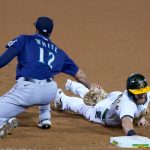 OAKLAND, CALIFORNIA - SEPTEMBER 25: Robbie Grossman #8 of the Oakland Athletics get picked off at first base tagged out by Evan White #12 of the Seattle Mariners in the bottom of the seventh inning at RingCentral Coliseum on September 25, 2020 in Oakland, California. (Photo by Thearon W. Henderson/Getty Images)