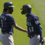 OAKLAND, CALIFORNIA - SEPTEMBER 27: J.P. Crawford #3 of the Seattle Mariners is congratulated by Evan White #12 after Crawford scored against the Oakland Athletics in the top of the first inning at RingCentral Coliseum on September 27, 2020 in Oakland, California. (Photo by Thearon W. Henderson/Getty Images)