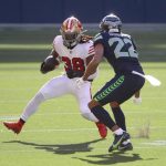 SEATTLE, WASHINGTON - NOVEMBER 01: JaMycal Hasty #38 of the San Francisco 49ers runs against Quinton Dunbar #22 of the Seattle Seahawks in the first half of the game at CenturyLink Field on November 01, 2020 in Seattle, Washington. (Photo by Abbie Parr/Getty Images)