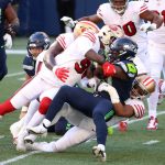 SEATTLE, WASHINGTON - NOVEMBER 01: DeeJay Dallas #31 of the Seattle Seahawks is tackled by the San Francisco 49ers in the first quarter of the game at CenturyLink Field on November 01, 2020 in Seattle, Washington. (Photo by Abbie Parr/Getty Images)