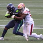SEATTLE, WASHINGTON - NOVEMBER 01: DeeJay Dallas #31 of the Seattle Seahawks is tackled by Dre Greenlaw #57 of the San Francisco 49ers in the third quarter of the game at CenturyLink Field on November 01, 2020 in Seattle, Washington. (Photo by Abbie Parr/Getty Images)