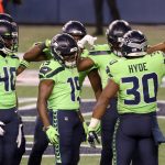 SEATTLE, WASHINGTON - NOVEMBER 19:  Carlos Hyde #30 of the Seattle Seahawks celebrates with teammates after he ran in for a touchdown against the Arizona Cardinals in the third quarter at Lumen Field on November 19, 2020 in Seattle, Washington. (Photo by Abbie Parr/Getty Images)