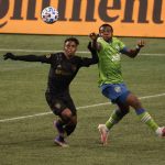 SEATTLE, WASHINGTON - NOVEMBER 24: Latif Blessing #7 of Los Angeles FC and Nouhou Tolo #5 of Seattle Sounders battle for possession in the second half during Round One of the MLS Cup Playoffs at Lumen Field Field on November 24, 2020 in Seattle, Washington. (Photo by Abbie Parr/Getty Images)