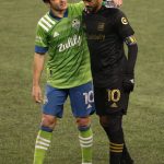 SEATTLE, WASHINGTON - NOVEMBER 24: Nicolas Lodeiro #10 of Seattle Sounders and Carlos Vela #10 of Los Angeles FC have a conversation after the Seattle Sounders defeated Los Angeles FC 3-1 during Round One of the MLS Cup Playoffs at Lumen Field Field on November 24, 2020 in Seattle, Washington. (Photo by Abbie Parr/Getty Images)