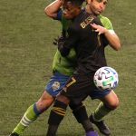 SEATTLE, WASHINGTON - NOVEMBER 24: Nicolas Lodeiro #10 of Seattle Sounders and Latif Blessing #7 of Los Angeles FC battle for possession in the second half during Round One of the MLS Cup Playoffs at Lumen Field Field on November 24, 2020 in Seattle, Washington. (Photo by Abbie Parr/Getty Images)