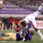 SEATTLE, WASHINGTON - NOVEMBER 28: Ty Jordan #22 of the Utah Utes is tackled by Jackson Sirmon #43 of the Washington Huskies in the first quarter at Husky Stadium on November 28, 2020 in Seattle, Washington. (Photo by Abbie Parr/Getty Images)