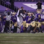 SEATTLE, WASHINGTON - NOVEMBER 28: The Washington Huskies celebrate an interception by Trent McDuffie #22 of the Washington Huskies during the final seconds of play to secure a 24-21 win against the Utah Utes at Husky Stadium on November 28, 2020 in Seattle, Washington. (Photo by Abbie Parr/Getty Images)