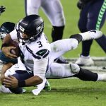 PHILADELPHIA, PENNSYLVANIA - NOVEMBER 30: Russell Wilson #3 of the Seattle Seahawks is tackled by T.J. Edwards #57 of the Philadelphia Eagles during the first quarter at Lincoln Financial Field on November 30, 2020 in Philadelphia, Pennsylvania. (Photo by Elsa/Getty Images)