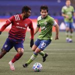 SEATTLE, WASHINGTON - DECEMBER 01: Thiago Santos #5 of FC Dallas controls the ball against Nicolas Lodeiro #10 of Seattle Sounders in the first half during their Western Conference Semifinal game at Lumen Field on December 01, 2020 in Seattle, Washington. (Photo by Abbie Parr/Getty Images)