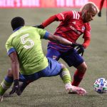 SEATTLE, WASHINGTON - DECEMBER 01: Michael Barrios #21 of FC Dallas and Nouhou Tolo #5 of Seattle Sounders battle for possession in the second half during their Western Conference Semifinal game at Lumen Field on December 01, 2020 in Seattle, Washington. (Photo by Abbie Parr/Getty Images)