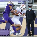 SEATTLE, WASHINGTON - DECEMBER 05: Brycen Tremayne #81 of the Stanford Cardinal completes a catch against Keith Taylor #8 of the Washington Huskies in the third quarter at Husky Stadium on December 05, 2020 in Seattle, Washington. (Photo by Abbie Parr/Getty Images)