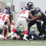 SEATTLE, WASHINGTON - DECEMBER 06: Russell Wilson #3 of the Seattle Seahawks fumbles the ball against the New York Giants during the second quarter in the game at Lumen Field on December 06, 2020 in Seattle, Washington. (Photo by Abbie Parr/Getty Images)