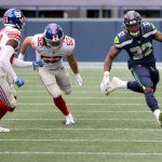 SEATTLE, WASHINGTON - DECEMBER 06: Chris Carson #32 of the Seattle Seahawks runs with the ball against the New York Giants during the second quarter in the game at Lumen Field on December 06, 2020 in Seattle, Washington. (Photo by Abbie Parr/Getty Images)