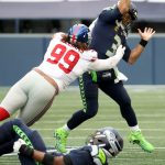 SEATTLE, WASHINGTON - DECEMBER 06: Russell Wilson #3 of the Seattle Seahawks is hit by Leonard Williams #99 of the New York Giants during the second quarter at Lumen Field on December 06, 2020 in Seattle, Washington. (Photo by Abbie Parr/Getty Images)