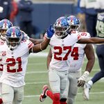 SEATTLE, WASHINGTON - DECEMBER 06: Jabrill Peppers #21 and Isaac Yiadom #27 of the New York Giants celebrate an interception by Darnay Holmes #30 (not pictured) a with  in the game at Lumen Field on December 06, 2020 in Seattle, Washington. (Photo by Abbie Parr/Getty Images)