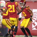 LOS ANGELES, CALIFORNIA - DECEMBER 06: Vavae Malepeai #29, and Tyler Vaughns #21 congratulate Amon-Ra St. Brown #8 of the USC Trojans after his reception for a touchdown during the first half of a game against the Washington State Cougars at Los Angeles Coliseum on December 06, 2020 in Los Angeles, California. (Photo by Sean M. Haffey/Getty Images)
