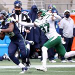 SEATTLE, WASHINGTON - DECEMBER 13: David Moore #83 of the Seattle Seahawks misses a pass against Bryce Hall #37 of the New York Jets during the second quarter in the game at Lumen Field on December 13, 2020 in Seattle, Washington. (Photo by Abbie Parr/Getty Images)
