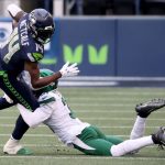 SEATTLE, WASHINGTON - DECEMBER 13: DK Metcalf #14 of the Seattle Seahawks gets tackled by Blessuan Austin #31 of the New York Jets during the second quarter in the game at Lumen Field on December 13, 2020 in Seattle, Washington. (Photo by Abbie Parr/Getty Images)