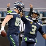 SEATTLE, WASHINGTON - DECEMBER 13: Will Dissly #89 of the Seattle Seahawks celebrates with Russell Wilson #3 after scoring a 10 yard touchdown against the New York Jets during the third quarter in the game at Lumen Field on December 13, 2020 in Seattle, Washington. (Photo by Abbie Parr/Getty Images)