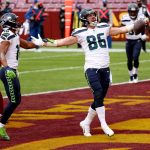 LANDOVER, MARYLAND - DECEMBER 20: Tight end Jacob Hollister #86 of the Seattle Seahawks celebrates with teammate Tyler Lockett #16 after catching a first half touchdown pass against the Washington Football Team at FedExField on December 20, 2020 in Landover, Maryland. (Photo by Patrick Smith/Getty Images)