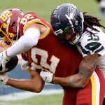 LANDOVER, MARYLAND - DECEMBER 20: Tight end Logan Thomas #82 of the Washington Football Team is tackled by strong safety Ryan Neal #35 of the Seattle Seahawks in the first half at FedExField on December 20, 2020 in Landover, Maryland. (Photo by Tim Nwachukwu/Getty Images)